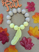 Load image into Gallery viewer, Yellow Feather Teething Ring, Silicone and Beechwood
